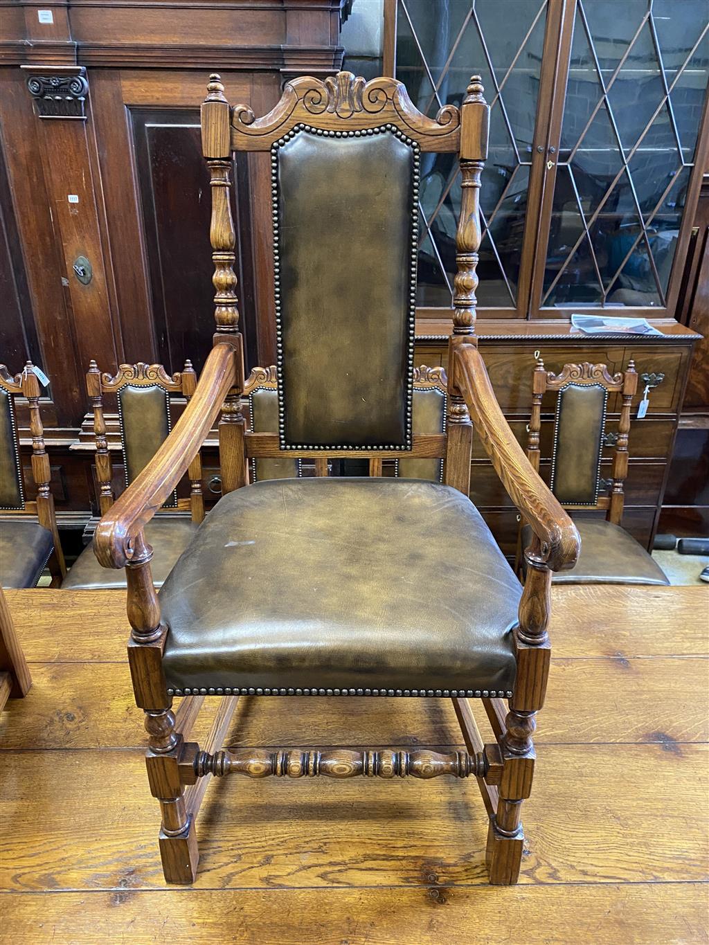 A set of ten 18th century style oak brown leather dining chairs (two with arms)